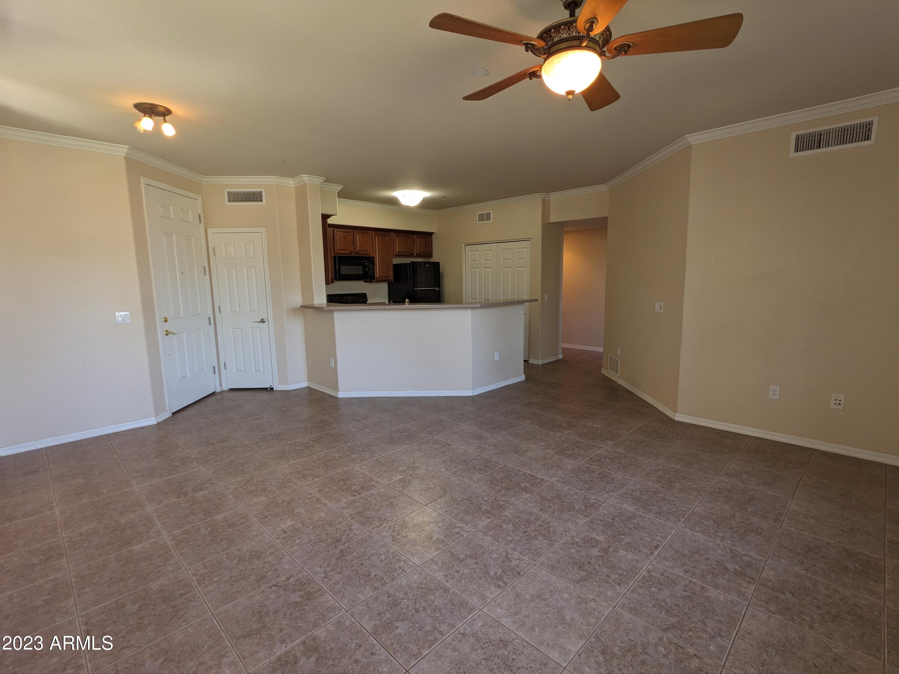 3330 South Gilbert Road, Unit 1007 Chandler, AZ 85286 - Photo 4 of 12 a view of a kitchen with a sink and a refrigerator