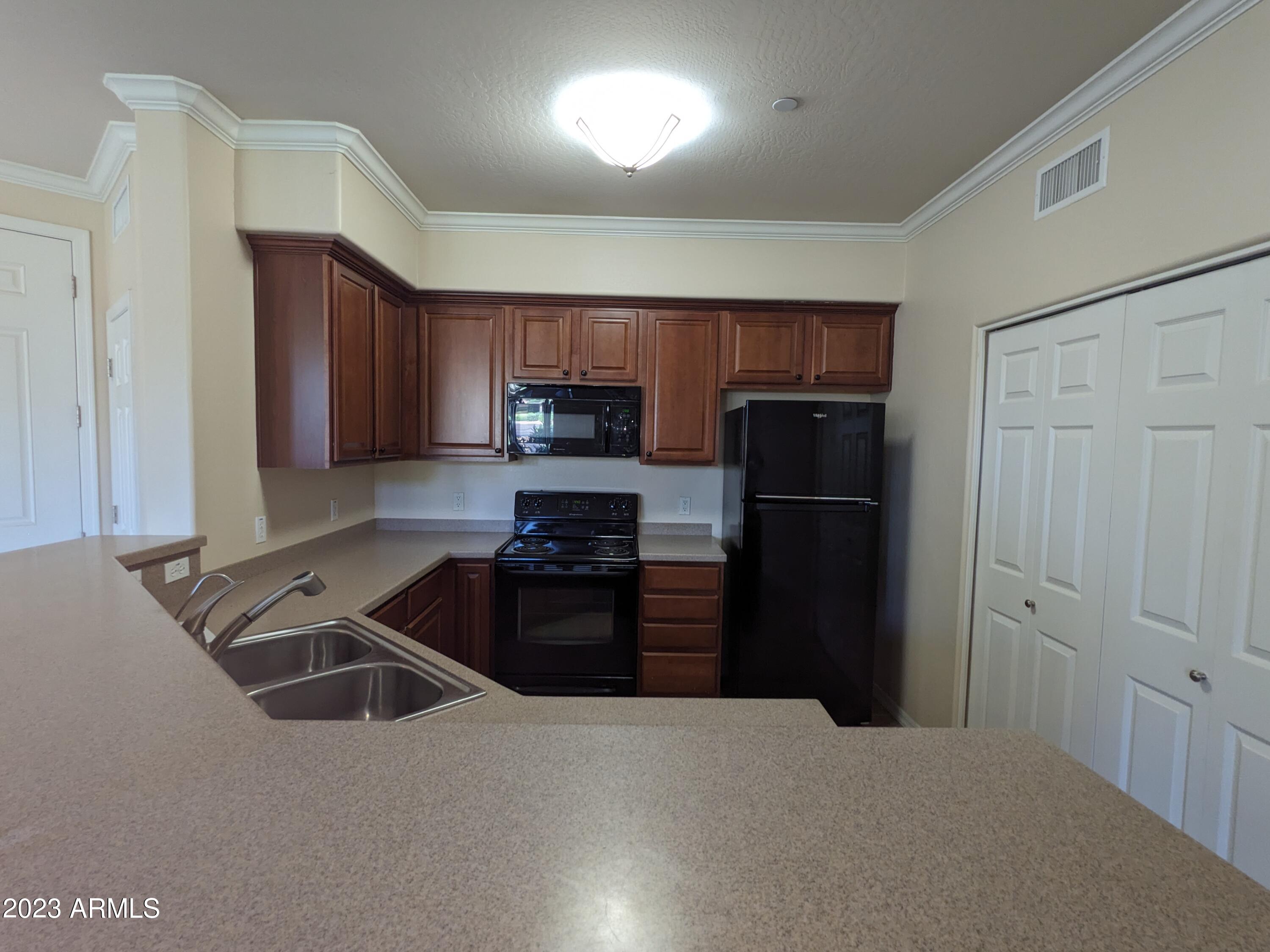 3330 South Gilbert Road, Unit 1007 Chandler, AZ 85286 - Photo 7 of 12 a kitchen with a refrigerator stove and sink