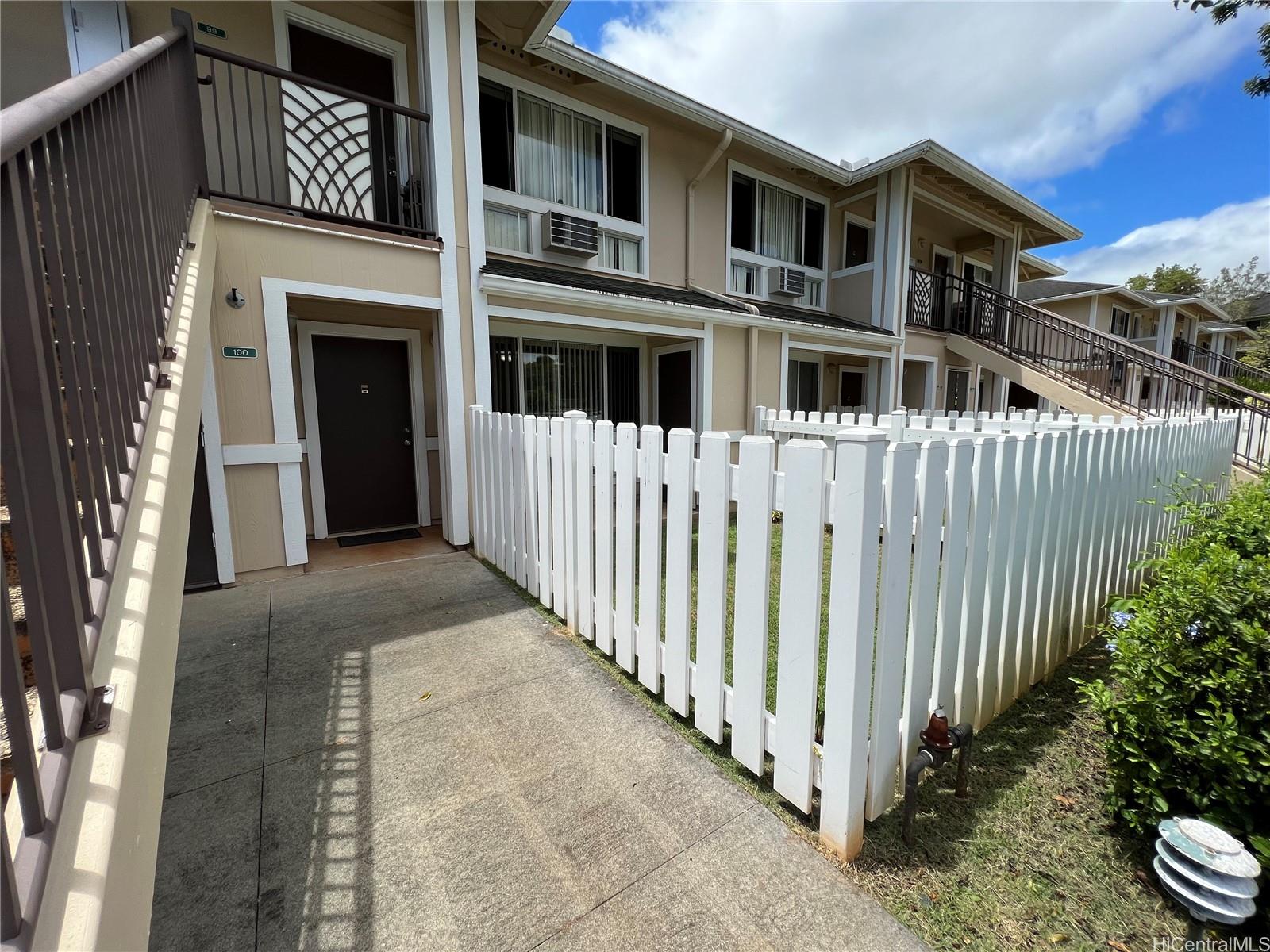 95-1145 Koolani Drive, Unit 100 Mililani, HI 96789 - Photo 2 of 9 a view of a brick house with many windows