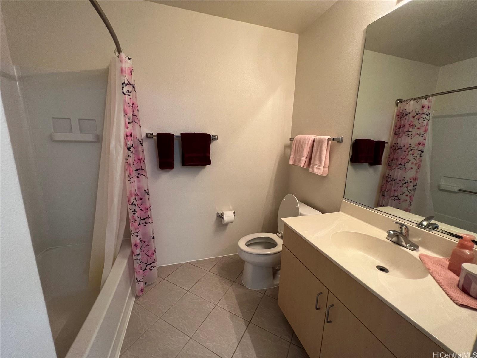 95-1145 Koolani Drive, Unit 100 Mililani, HI 96789 - Photo 8 of 9 a bathroom with a sink toilet and shower