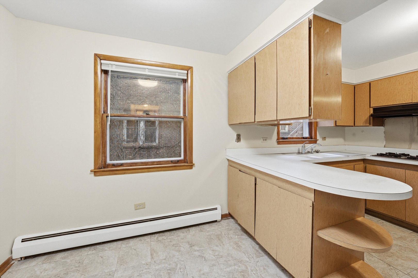 272 East 148th Street Harvey, IL 60426 - Photo 19 of 25 a kitchen with a sink cabinets and window