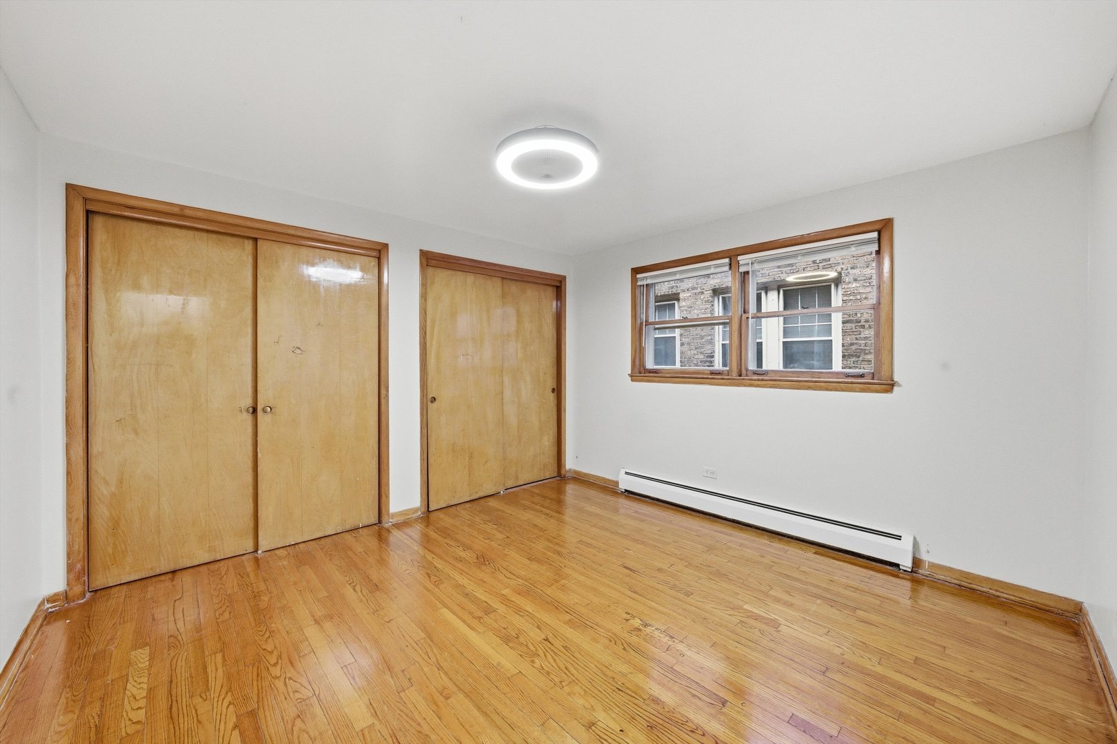 272 East 148th Street Harvey, IL 60426 - Photo 20 of 25 a view of an empty room with wooden floor and a window