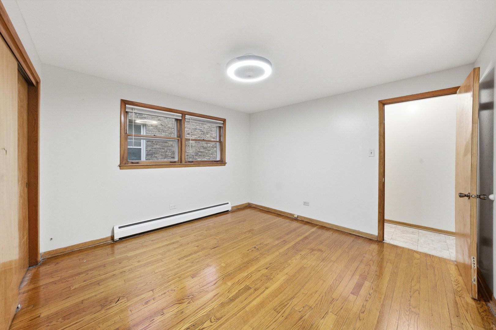 272 East 148th Street Harvey, IL 60426 - Photo 21 of 25 an empty room with wooden floor and windows