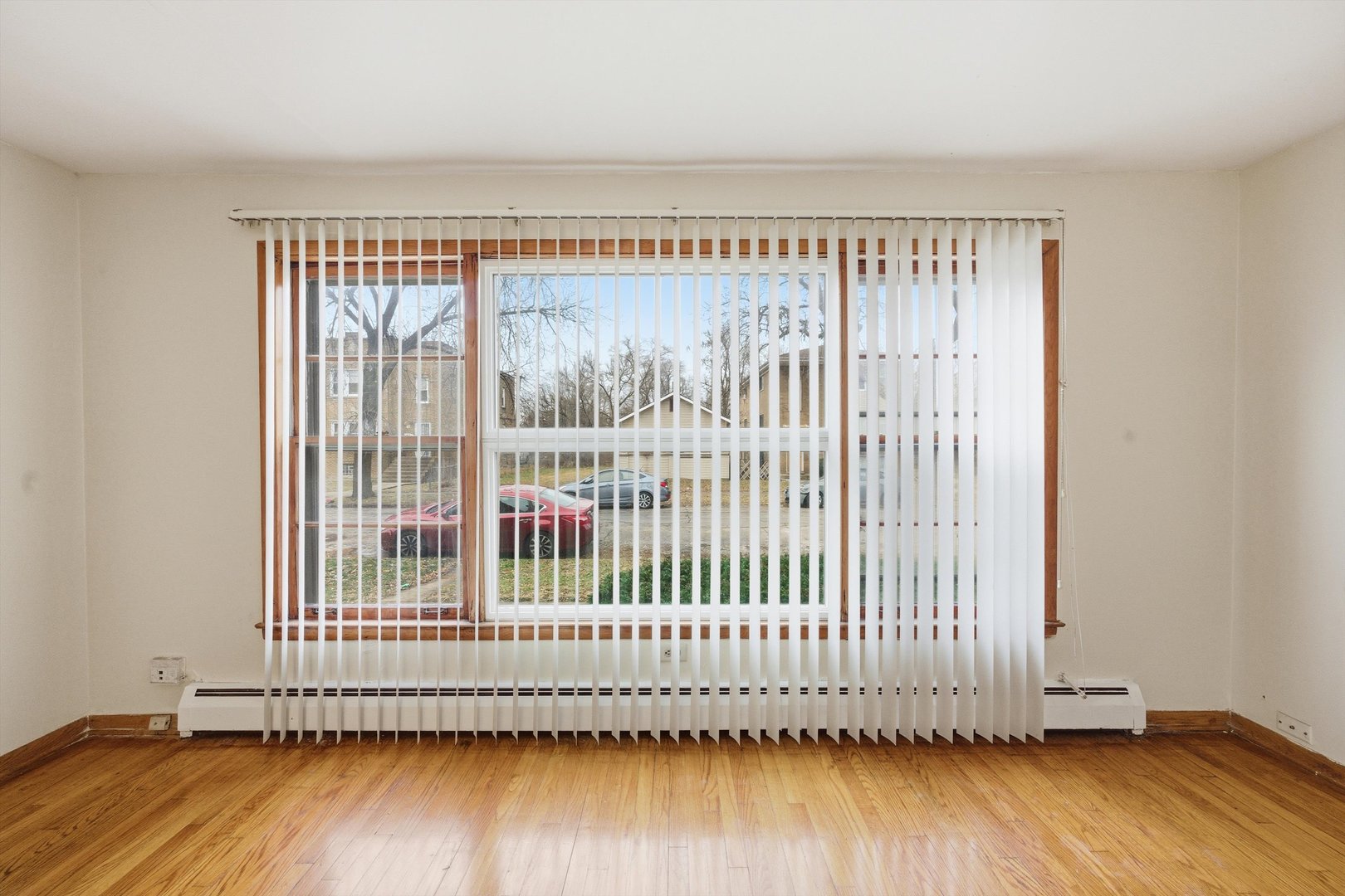272 East 148th Street Harvey, IL 60426 - Photo 6 of 25 a view of a livingroom with wooden floor and a window