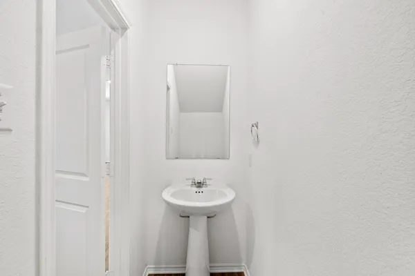 a view of a kitchen with wooden floor and a sink