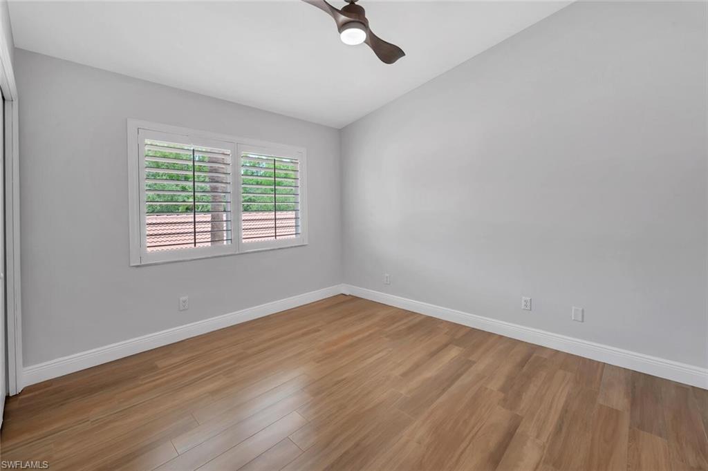6720 Beach Resort Drive, Unit 10 Naples, FL 34114 - Photo 15 of 34 Empty room with wood finished floors and a ceiling fan