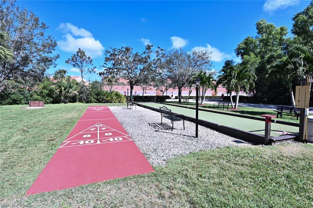 6720 Beach Resort Drive, Unit 10 Naples, FL 34114 - Photo 33 of 34 View of home's community with a game area, a lawn, and shuffleboard