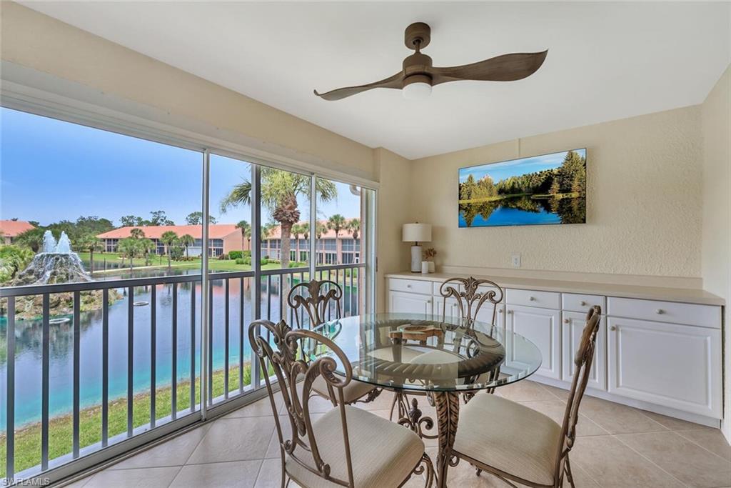 6720 Beach Resort Drive, Unit 10 Naples, FL 34114 - Photo 8 of 34 Sunroom Dining area with light tile patterned floors, ceiling fan, and a water view