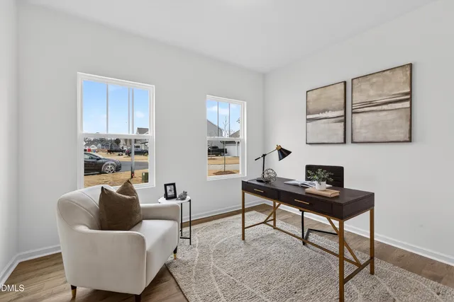 a work room with furniture and wooden floor