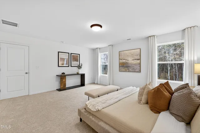 a bedroom with a large bed and a window