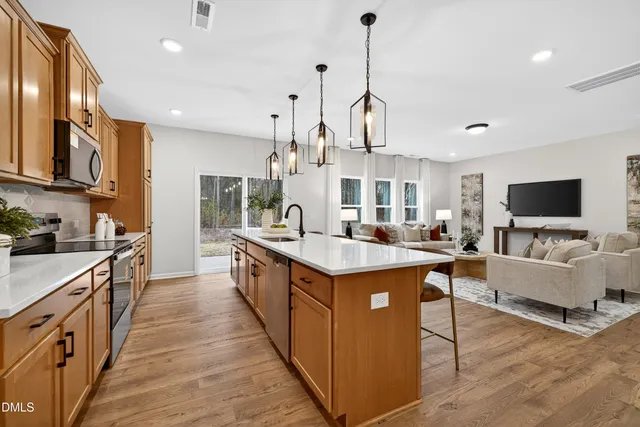 a kitchen with stainless steel appliances granite countertop a sink and a stove