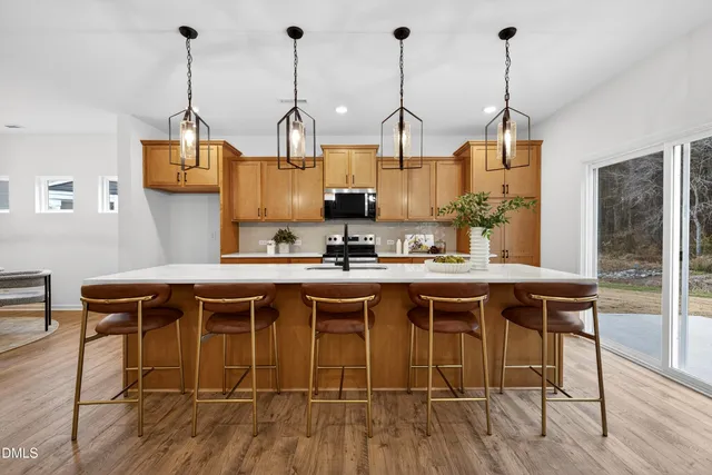 a kitchen with a table chairs and wooden floor