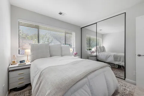 a bedroom with a bed and a mirror