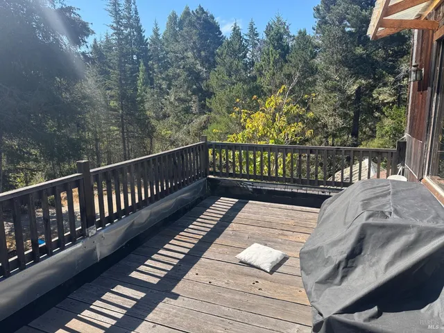 a view of a balcony with wooden floor