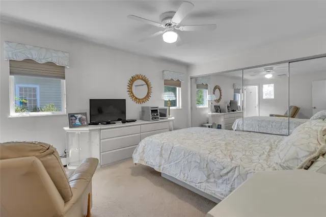 a large bedroom with a bed and a flat screen tv