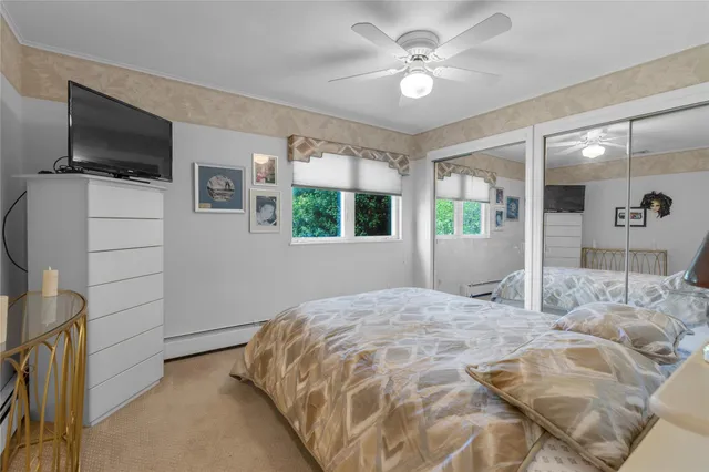 a bedroom with a large bed and a flat screen tv