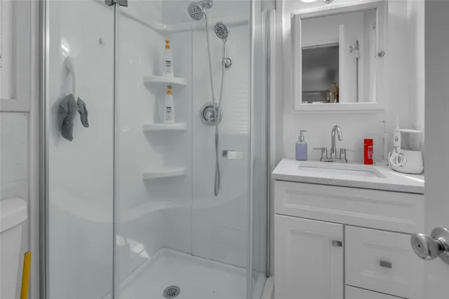 a bathroom with a shower and a sink