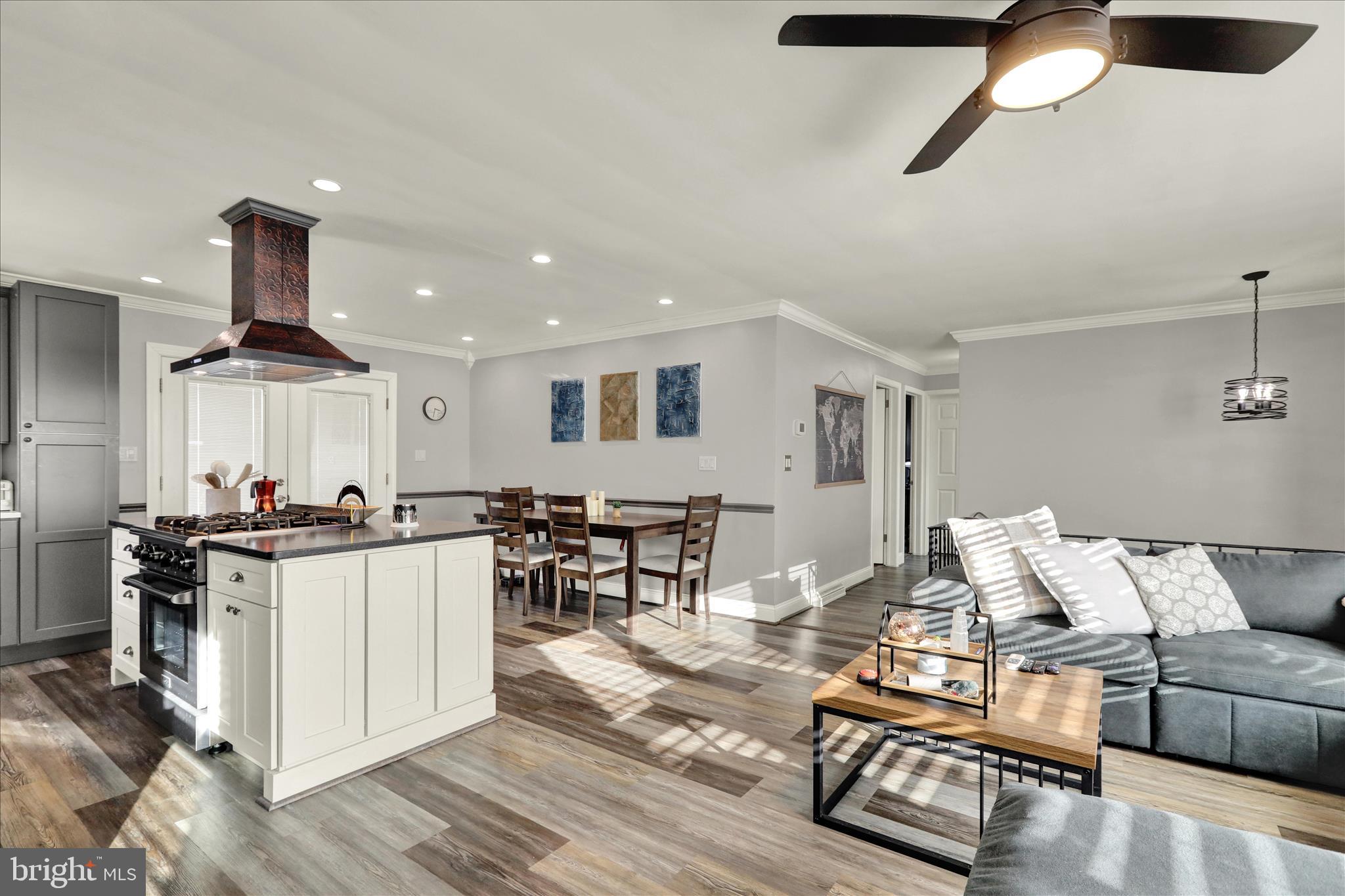 933 Philadelphia Avenue Reading, PA 19607 - Photo 11 of 34 a living room with furniture a wooden floor and kitchen view