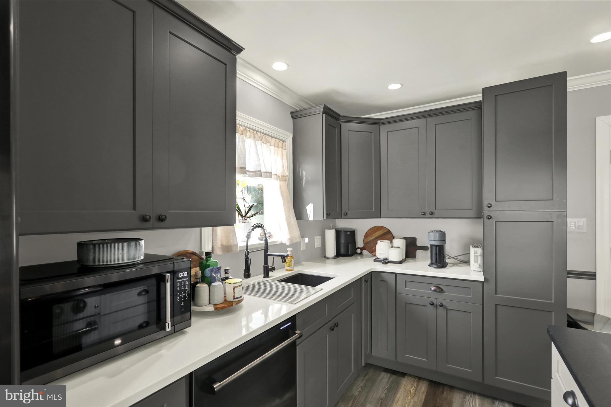 933 Philadelphia Avenue Reading, PA 19607 - Photo 13 of 34 a kitchen with sink cabinets and window
