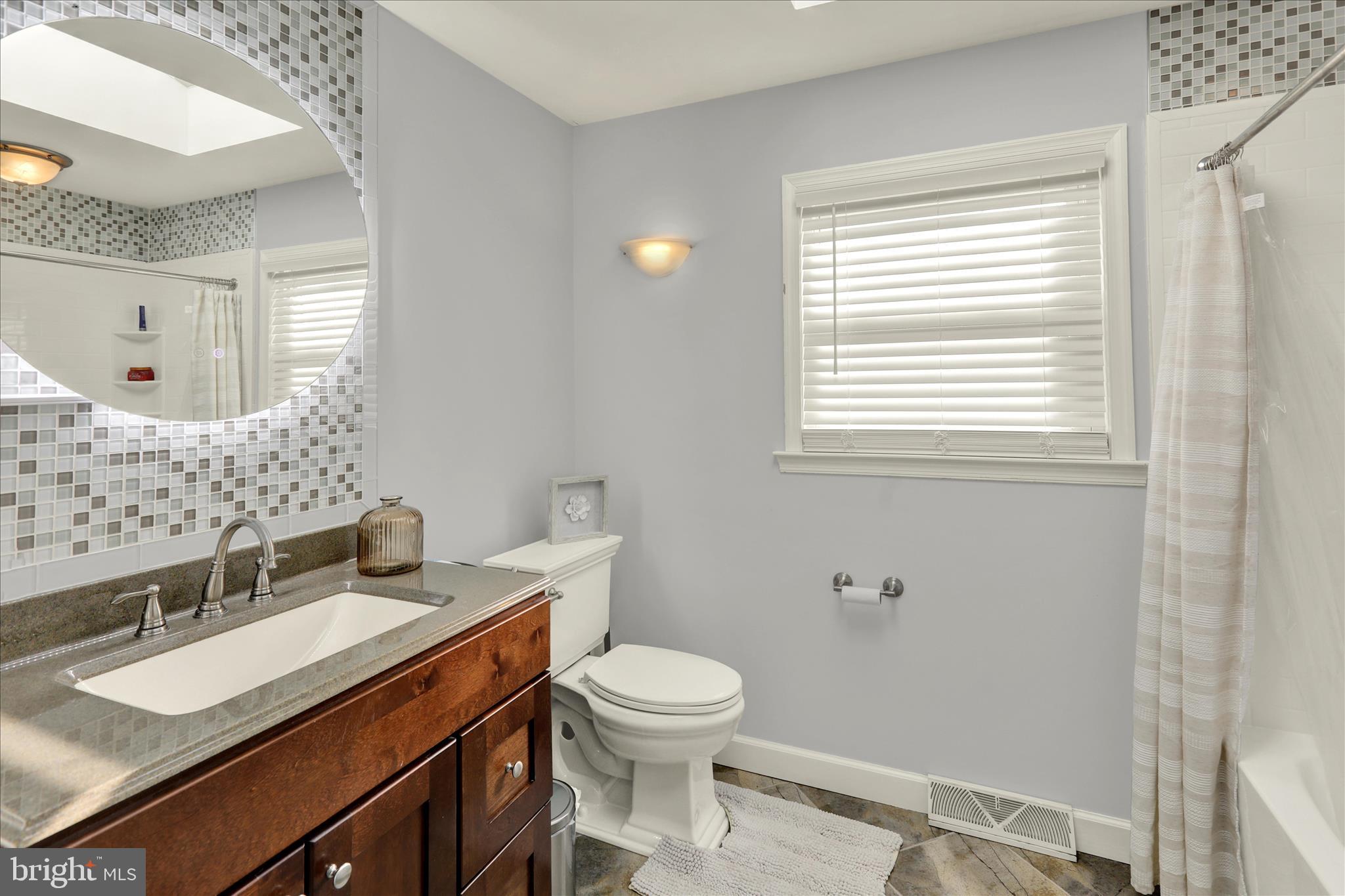 933 Philadelphia Avenue Reading, PA 19607 - Photo 22 of 34 a bathroom with a sink a toilet and a mirror