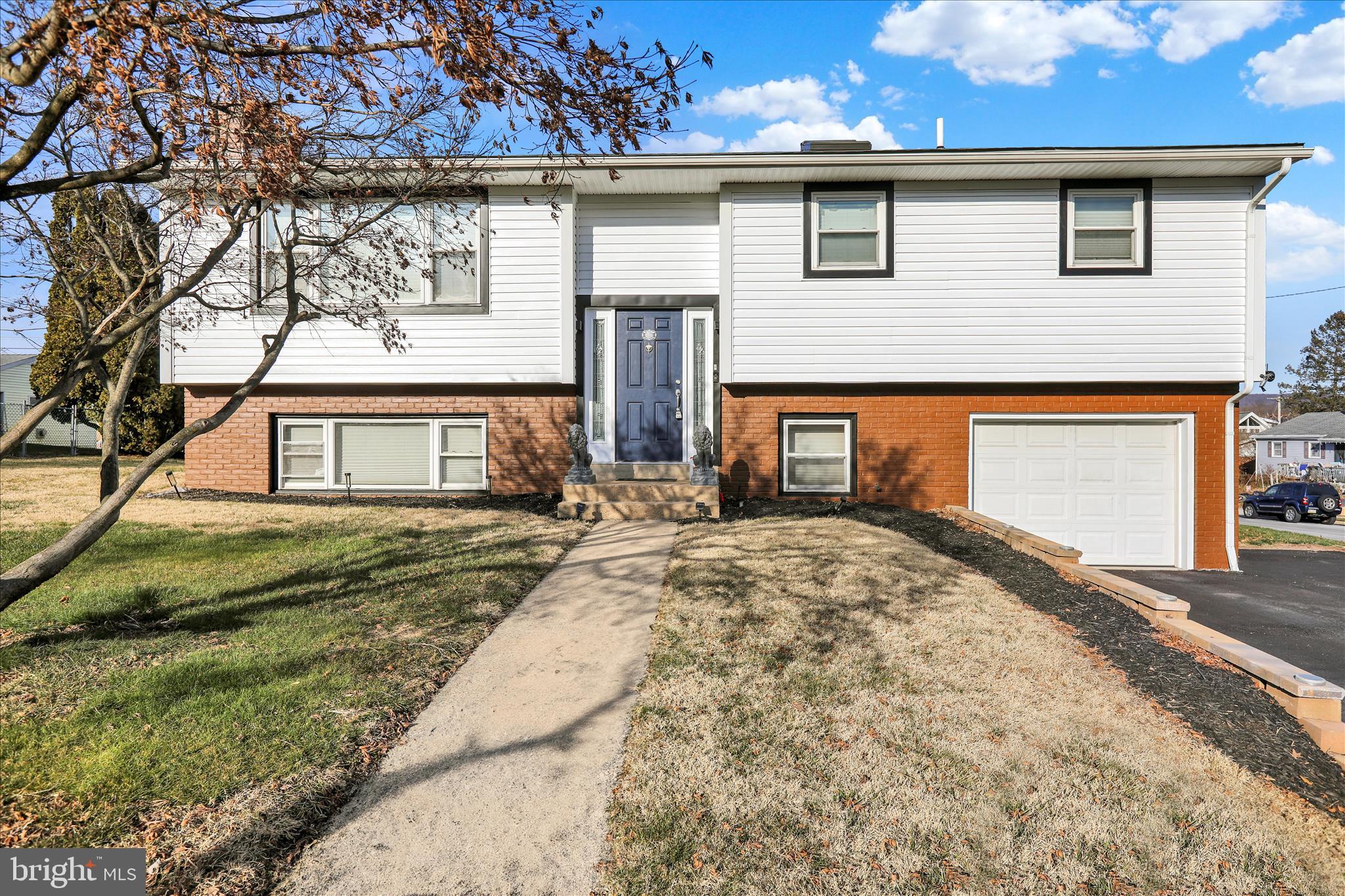 933 Philadelphia Avenue Reading, PA 19607 - Photo 3 of 34 a front view of a house with a yard and garage
