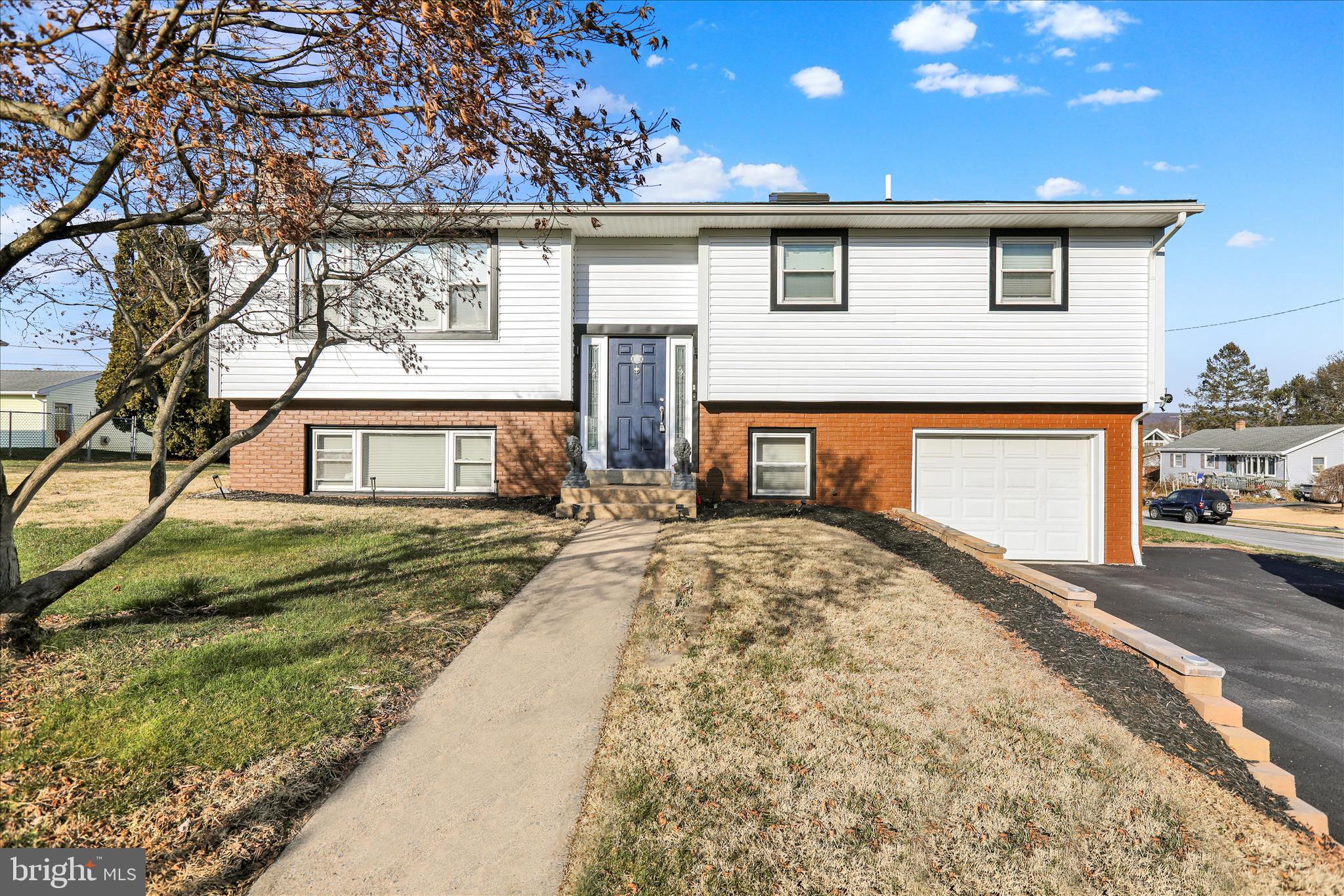933 Philadelphia Avenue Reading, PA 19607 - Photo 5 of 34 a front view of a house with a yard and garage