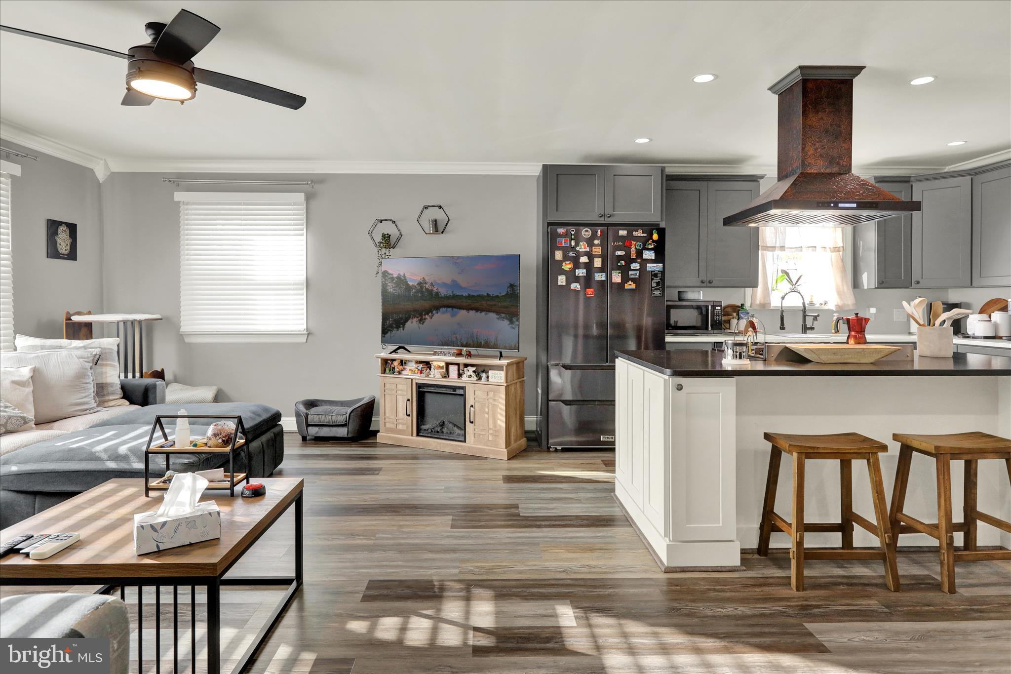 933 Philadelphia Avenue Reading, PA 19607 - Photo 7 of 34 a kitchen with stainless steel appliances granite countertop a stove top oven a sink a dining table and chairs with wooden floor