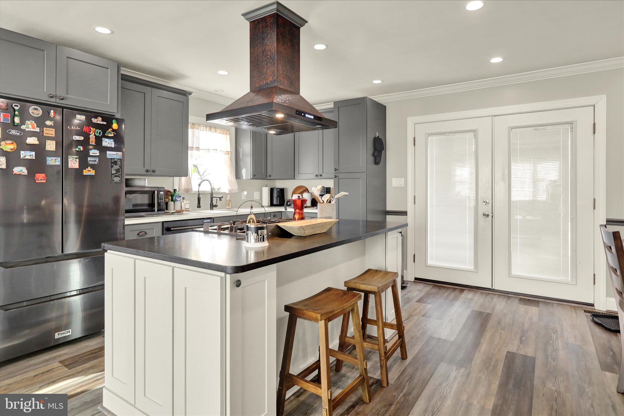 933 Philadelphia Avenue Reading, PA 19607 - Photo 10 of 34 a kitchen with stainless steel appliances granite countertop a sink and a refrigerator