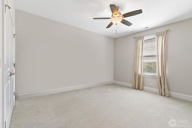 26021 West Sunset Road Barrington, IL 60010 - Photo 26 of 39 an empty room with windows and fan