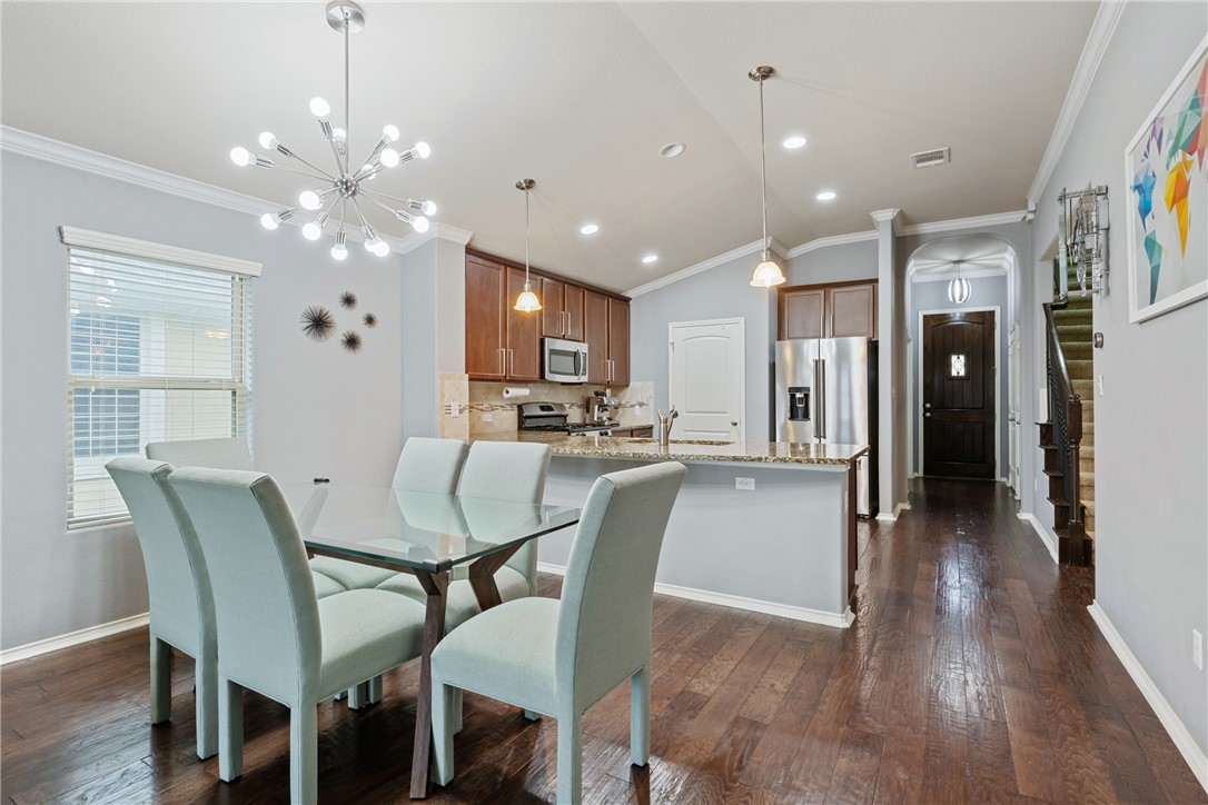 7310 Sunset Heights Circle, Unit F20 Austin, TX 78735 - Photo 12 of 32 a dining room with furniture and a chandelier