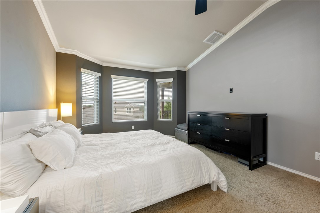 7310 Sunset Heights Circle, Unit F20 Austin, TX 78735 - Photo 18 of 32 a bedroom with a bed and a large window
