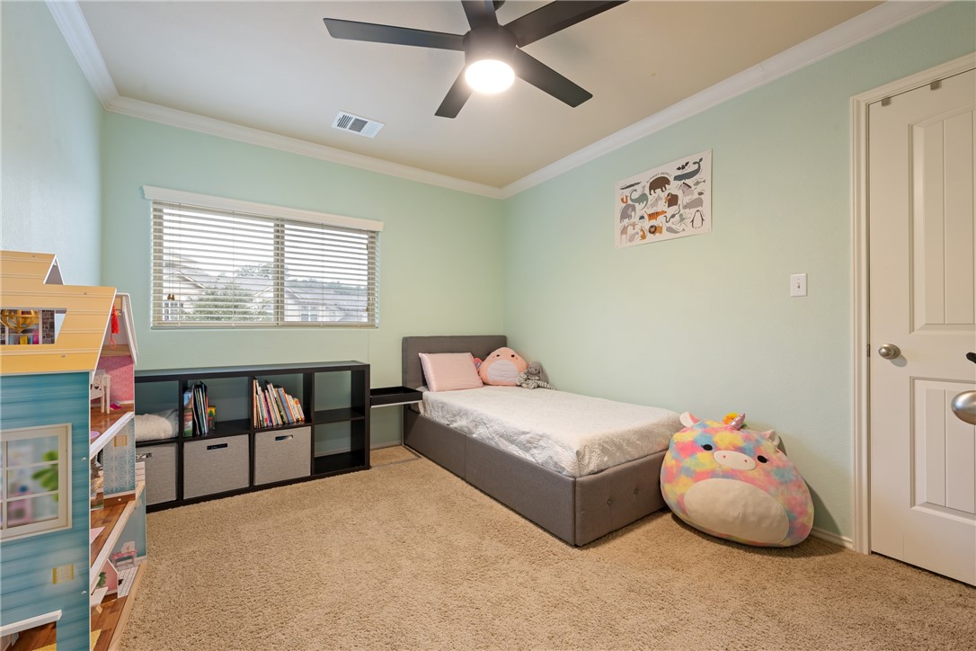 7310 Sunset Heights Circle, Unit F20 Austin, TX 78735 - Photo 23 of 32 a bedroom with a bed and a chandelier