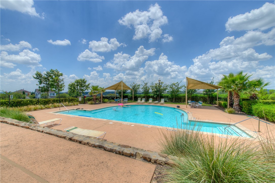 7310 Sunset Heights Circle, Unit F20 Austin, TX 78735 - Photo 30 of 32 a view of a swimming pool and a yard