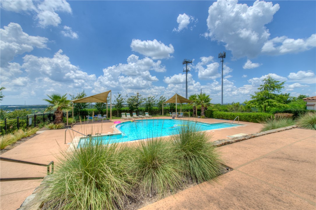 7310 Sunset Heights Circle, Unit F20 Austin, TX 78735 - Photo 31 of 32 a view of a swimming pool with a yard