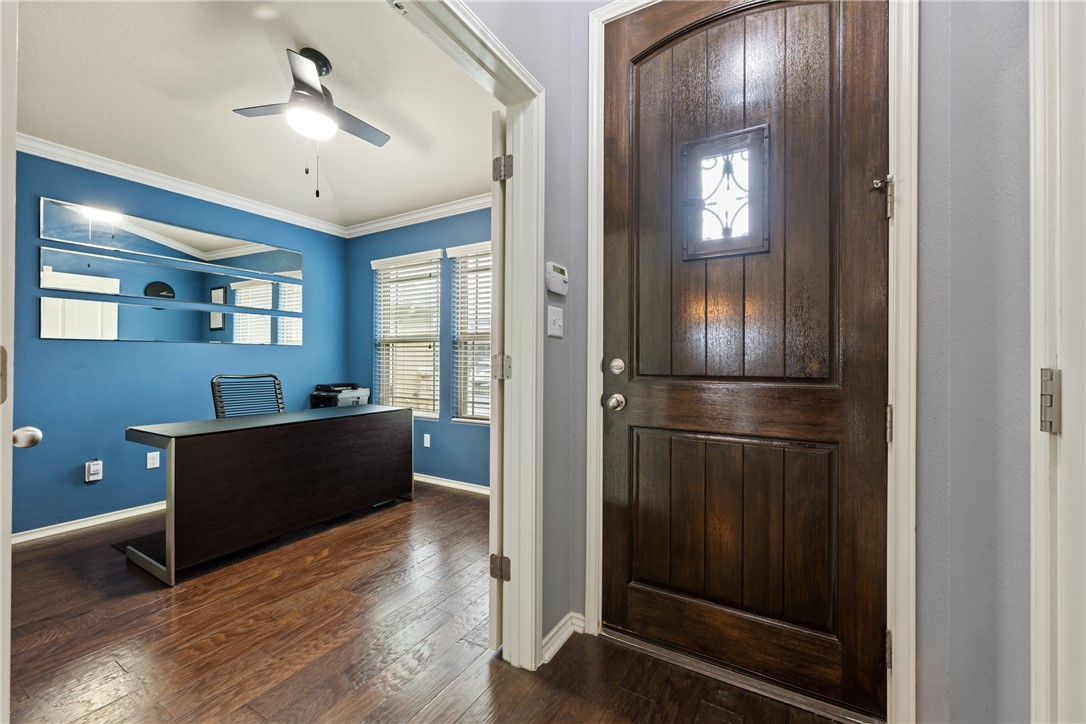 7310 Sunset Heights Circle, Unit F20 Austin, TX 78735 - Photo 5 of 32 a kitchen with a refrigerator and a wooden floor