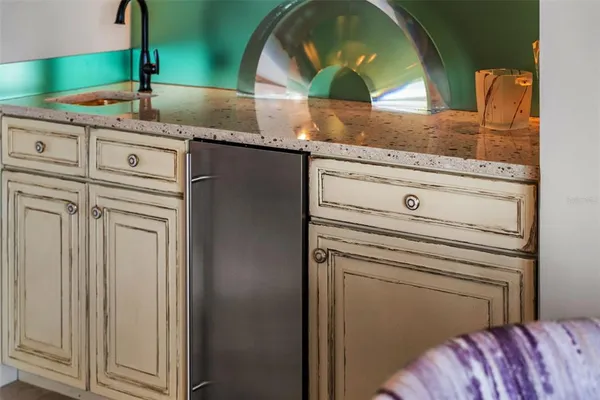 a view of a kitchen counter space a sink and wooden floor