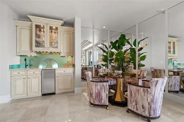 a kitchen with kitchen island granite countertop a sink window and cabinets