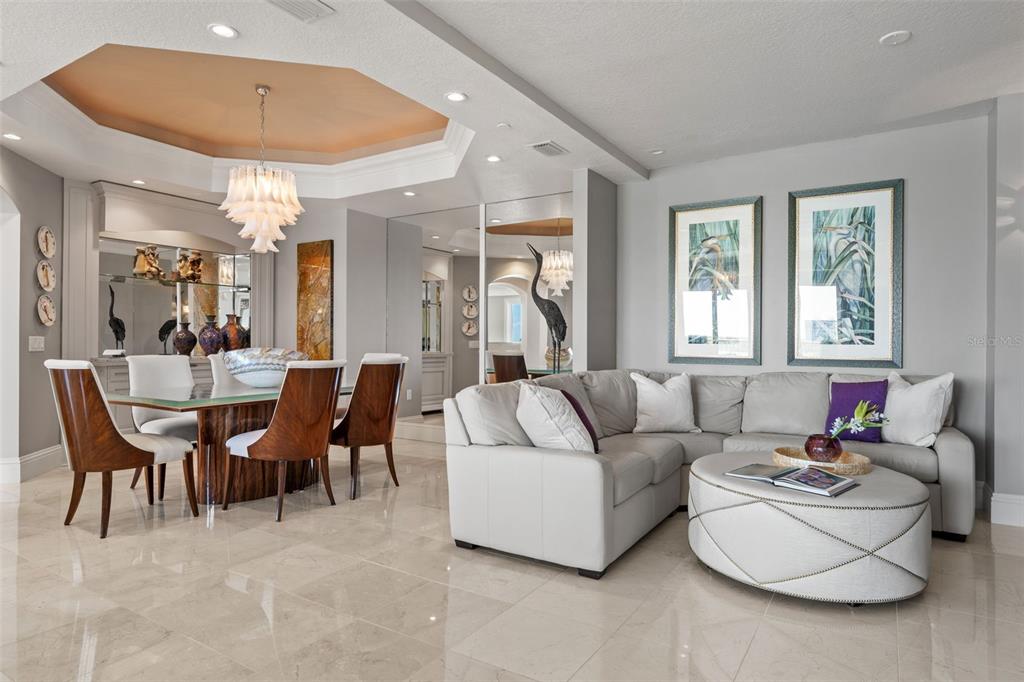 464 Golden Gate Point, Unit 703 Sarasota, FL 34236 - Photo 18 of 88 a living room with furniture and a large window