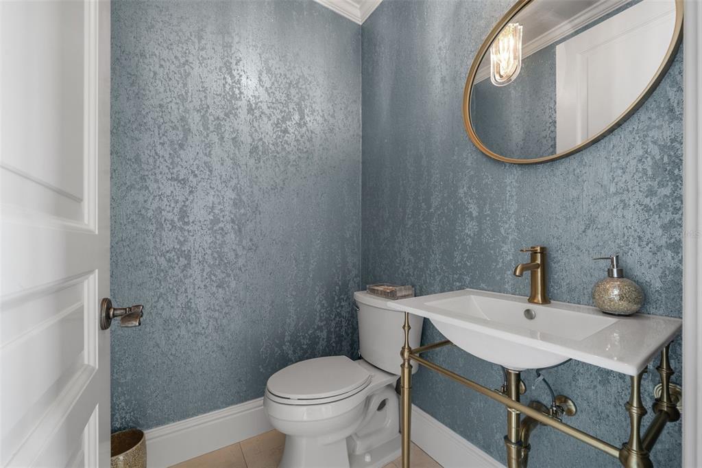 464 Golden Gate Point, Unit 703 Sarasota, FL 34236 - Photo 19 of 88 a bathroom with a sink toilet and mirror