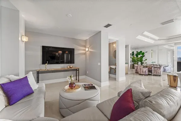 a living room with furniture and a floor to ceiling window
