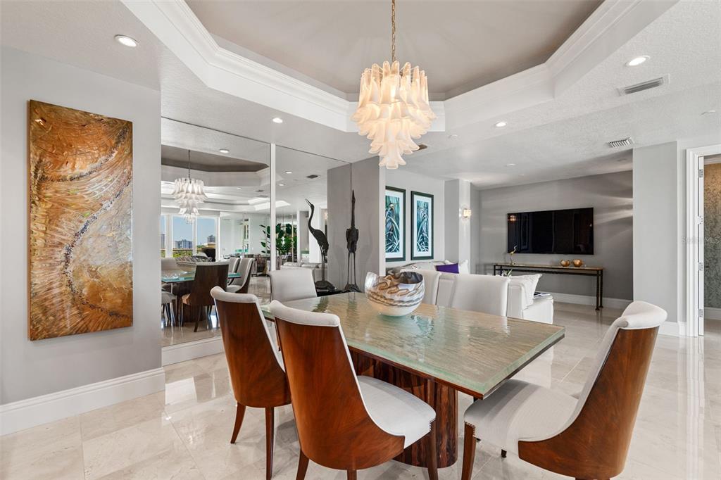 464 Golden Gate Point, Unit 703 Sarasota, FL 34236 - Photo 23 of 88 a view of a dining room with furniture window and wooden floor
