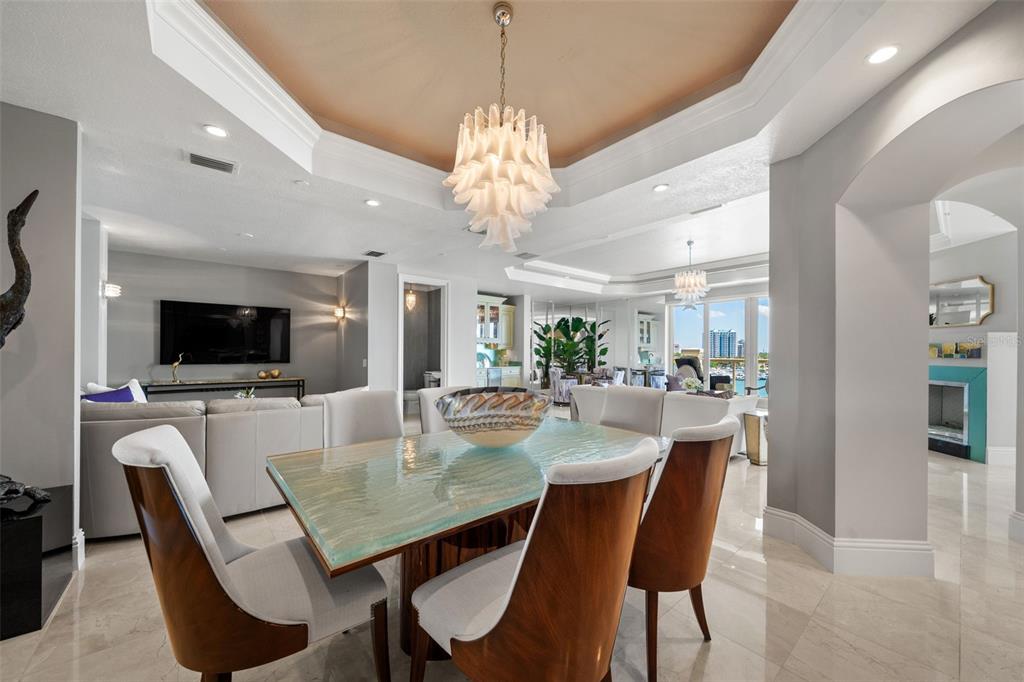 464 Golden Gate Point, Unit 703 Sarasota, FL 34236 - Photo 24 of 88 a view of a dining room with furniture window and wooden floor