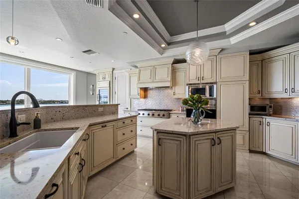 a kitchen with granite countertop a sink and a stove
