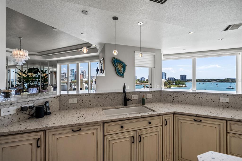464 Golden Gate Point, Unit 703 Sarasota, FL 34236 - Photo 27 of 88 a view of a kitchen counter space a sink and wooden floor