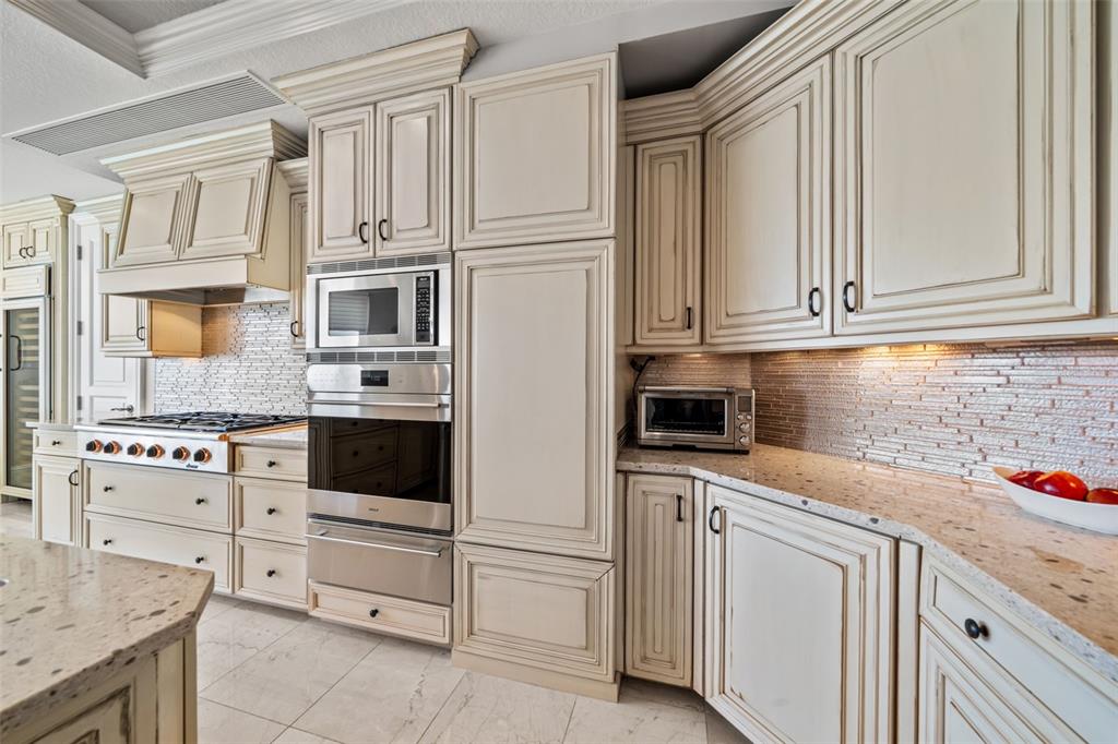 464 Golden Gate Point, Unit 703 Sarasota, FL 34236 - Photo 29 of 88 a kitchen with white cabinets and white appliances