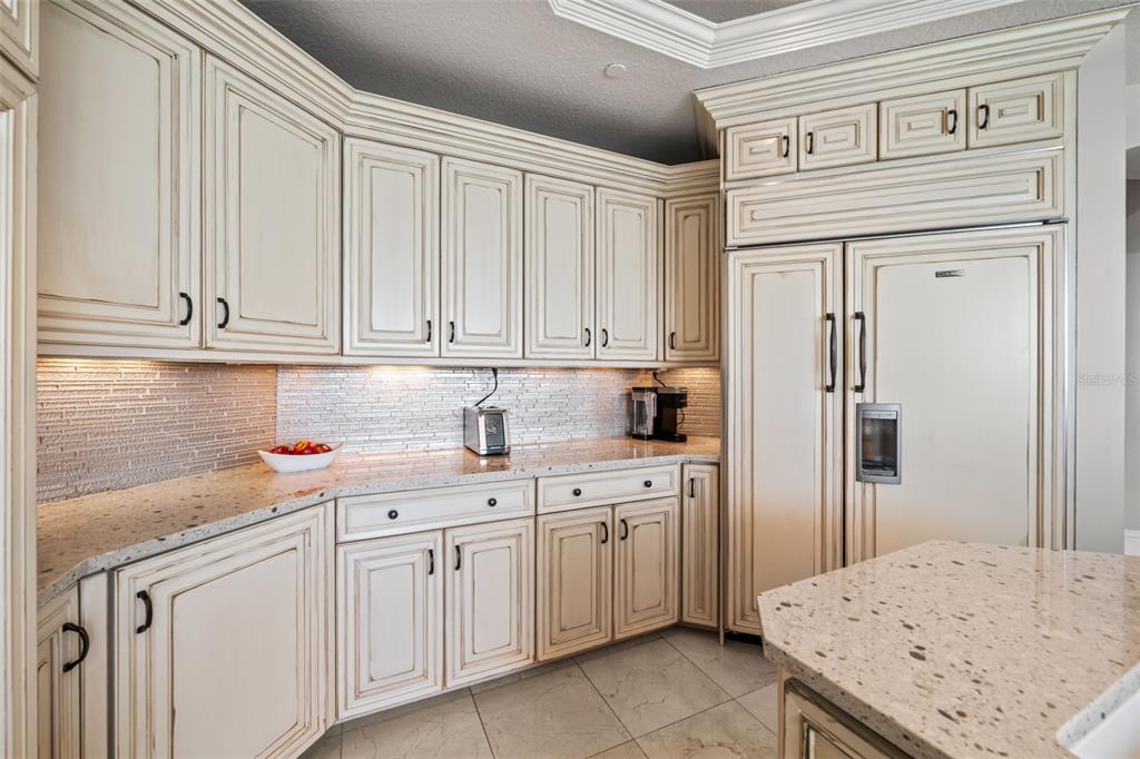 464 Golden Gate Point, Unit 703 Sarasota, FL 34236 - Photo 30 of 88 a kitchen with white cabinets and sink