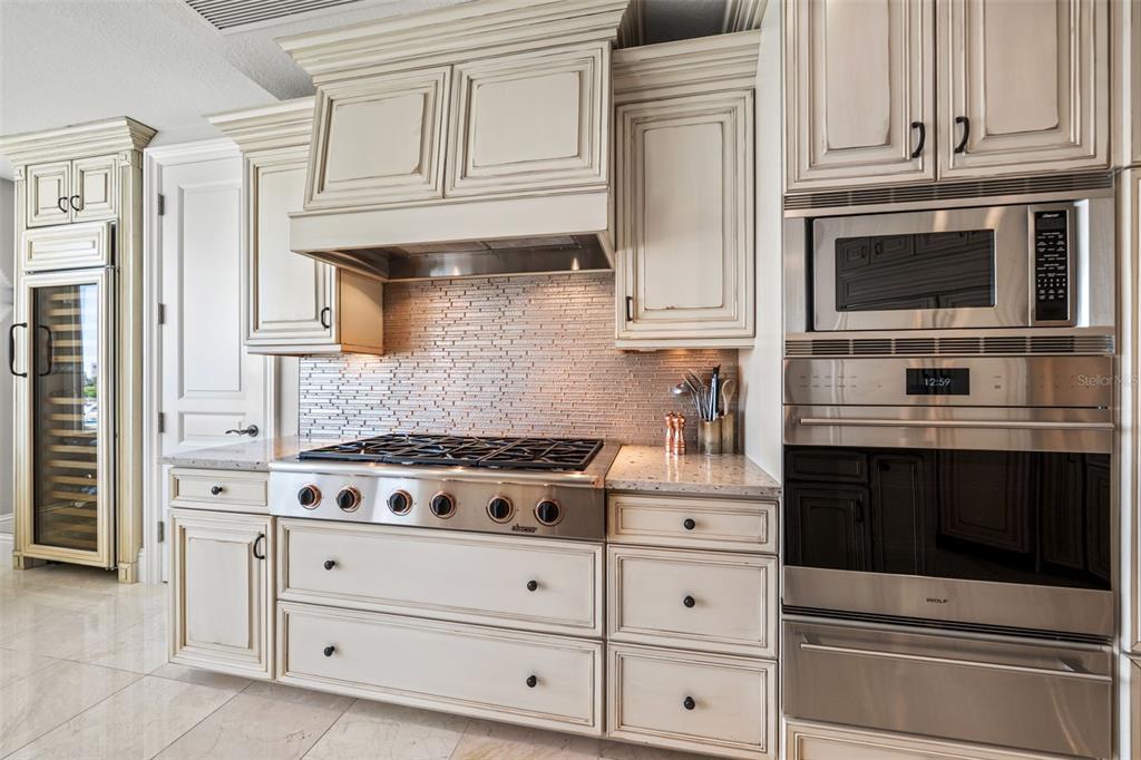 464 Golden Gate Point, Unit 703 Sarasota, FL 34236 - Photo 31 of 88 a kitchen with stainless steel appliances granite countertop white cabinets and a stove a oven with granite countertops