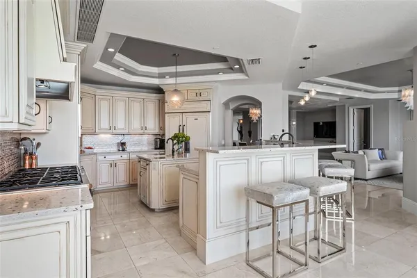 a bathroom with a granite countertop sink a toilet a mirror and bathtub