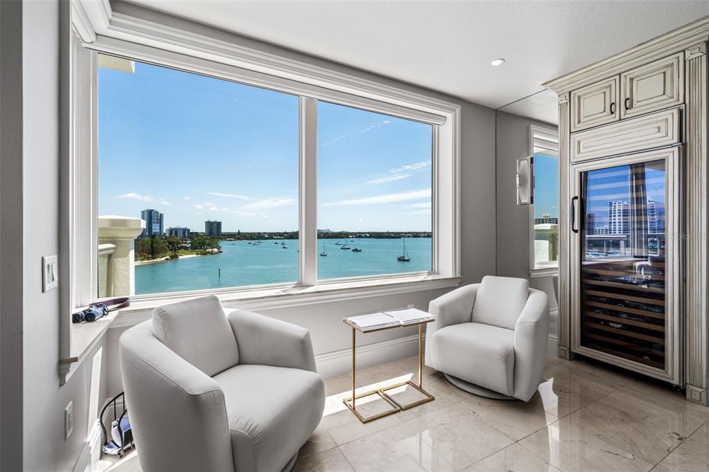 464 Golden Gate Point, Unit 703 Sarasota, FL 34236 - Photo 33 of 88 a living room with furniture and a floor to ceiling window