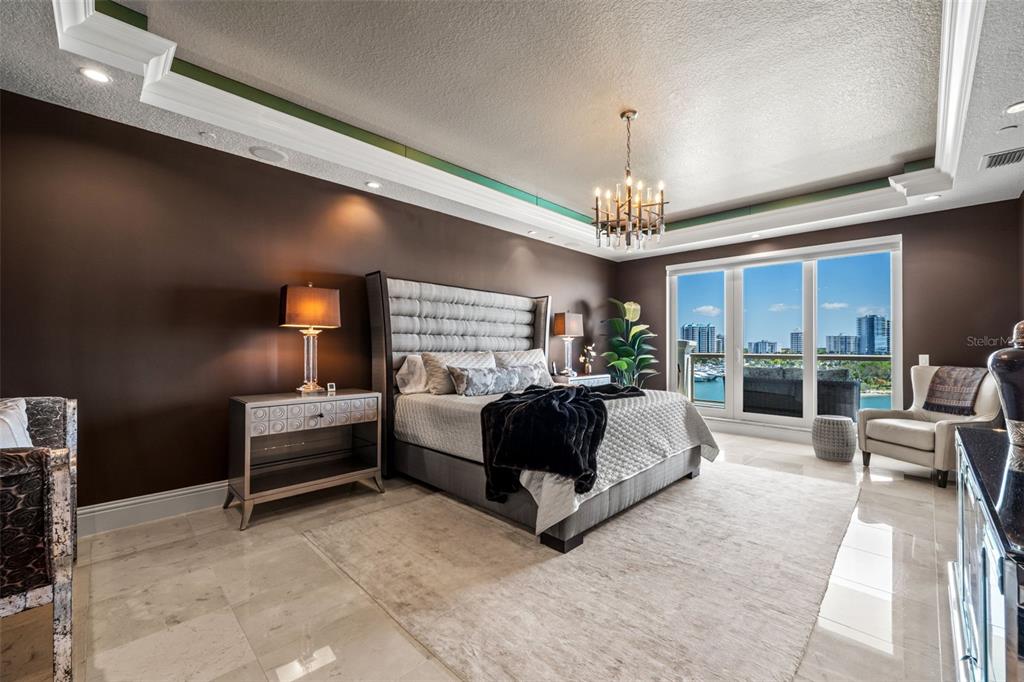 464 Golden Gate Point, Unit 703 Sarasota, FL 34236 - Photo 42 of 88 a living room with furniture and a chandelier